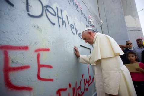 Pope Francis touches the wall that divides Israel from the West Bank in the West Bank city of Bethlehem